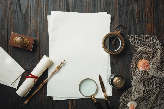Creative Non-Fiction old fashioned flat lay with letters writing accessories dark wooden table 1